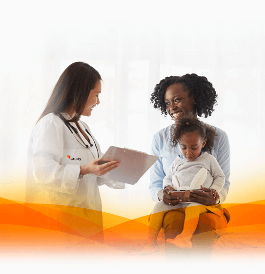 Vituity doctor smiling with patients who are mother and daughter