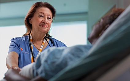 female Vituity medical professional comforting patient