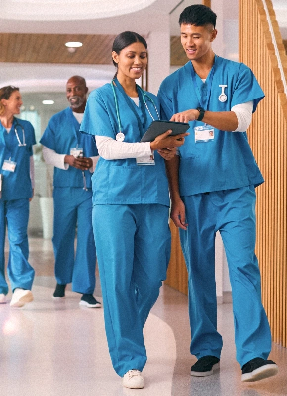 Two doctors walking down hospital atrium