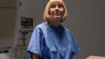 Image of female patient in hospital gown to address opioid addiction in the emergency room