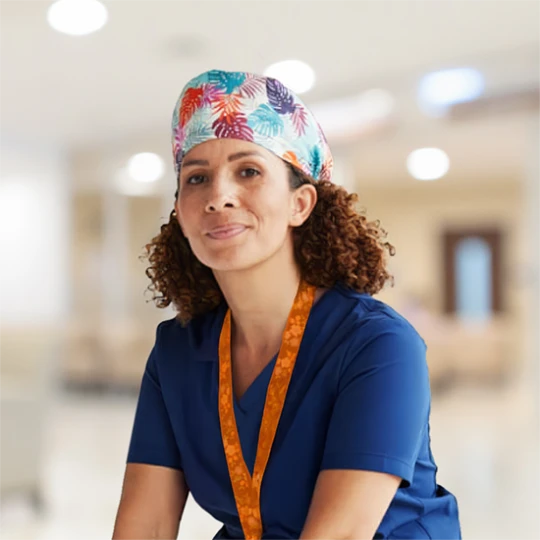 Healthcare professional in scrubs in hospital hallway symbolizing transition from training to clinical practice