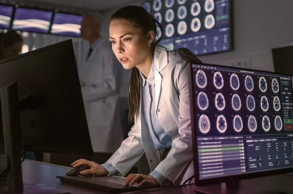 neurologist reviewing digital brain scans 