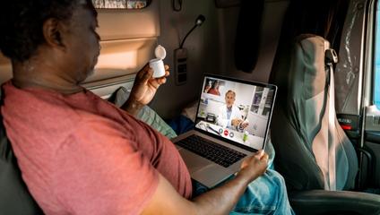 Virtual hospital image of patient speaking with doctor via laptop telehealth appointment
