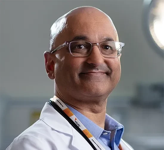 male vituity physician with  white lab coat and stethoscope around neck