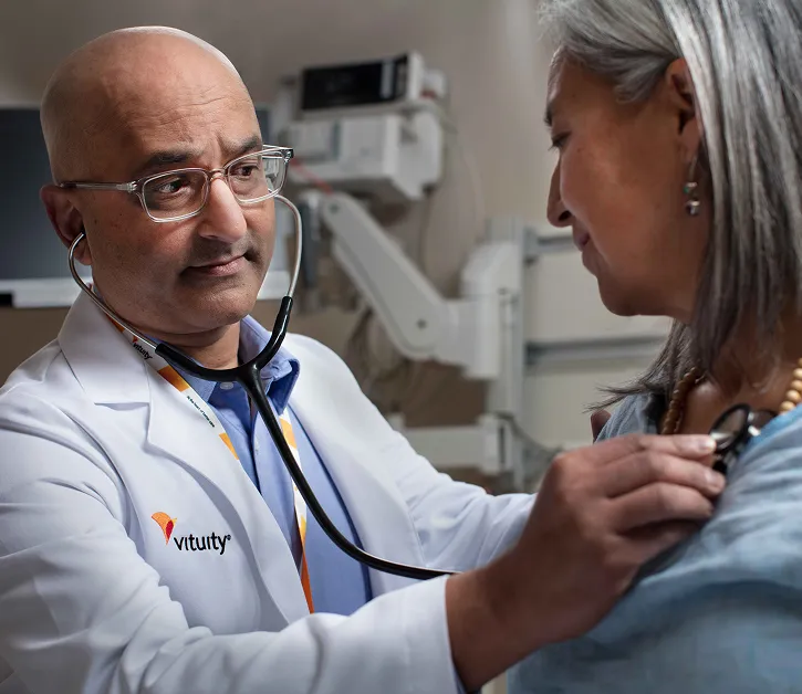 Vituity Medical professional with stethoscope examining patient