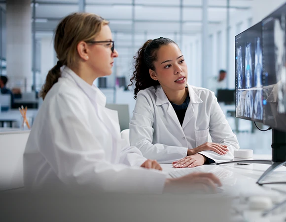 male vituity physician with  white lab coat and stethoscope around neck