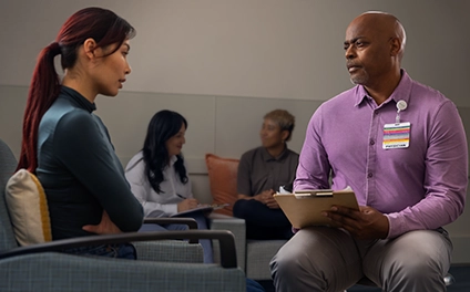 Vituity Psychiatrist Holding Clipboard Speaking With Patient