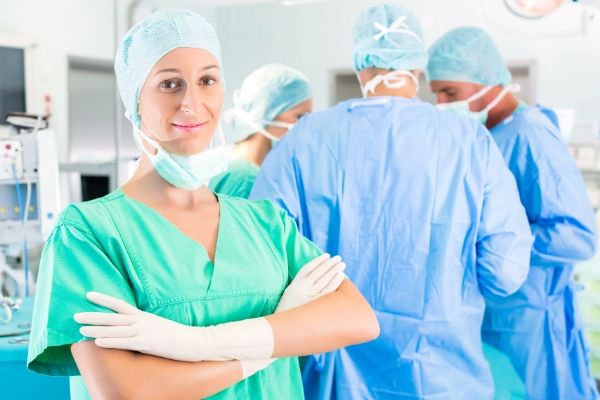 Smiling woman anesthesiologist in operating room