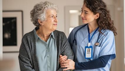 Physician assisting elderly patient walk, transitioning to post-acute care