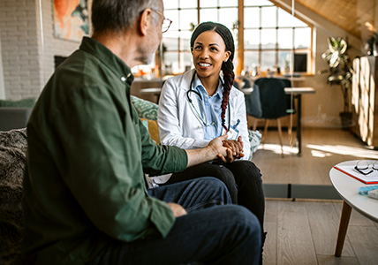 Doctor and patient talk holding hands