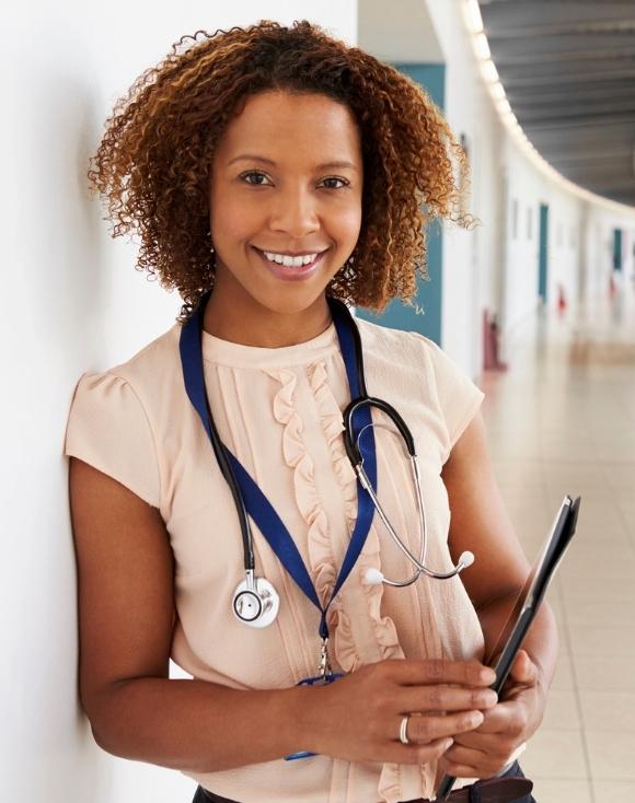 Young female physicians assistant holding tablet
