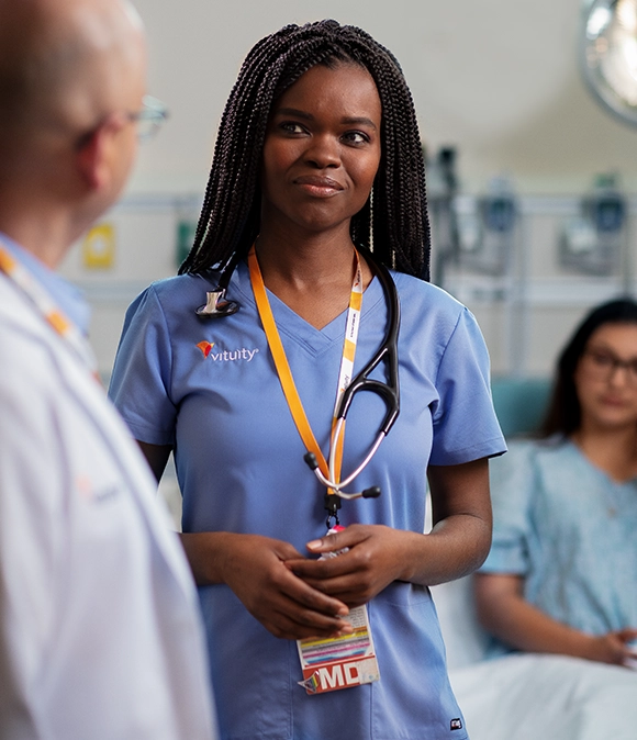 Vituity medical professionals in discussion in patients hospital room