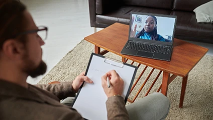 Online psychotherapy session on laptop