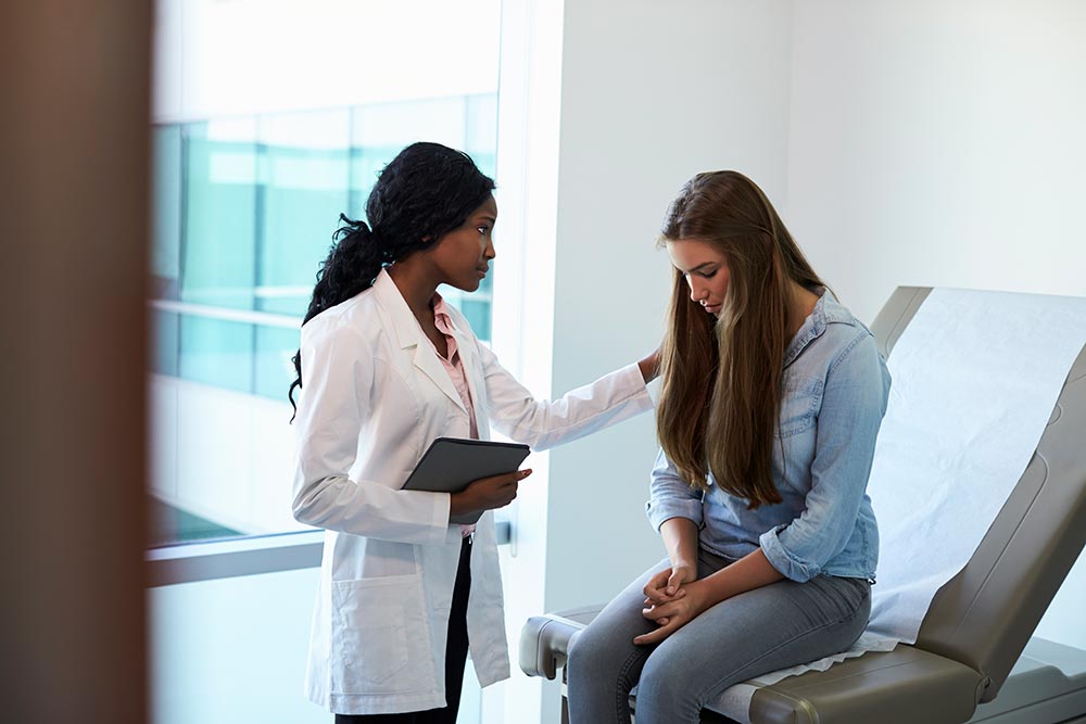 Physician helping a behavioral health patient in the ED