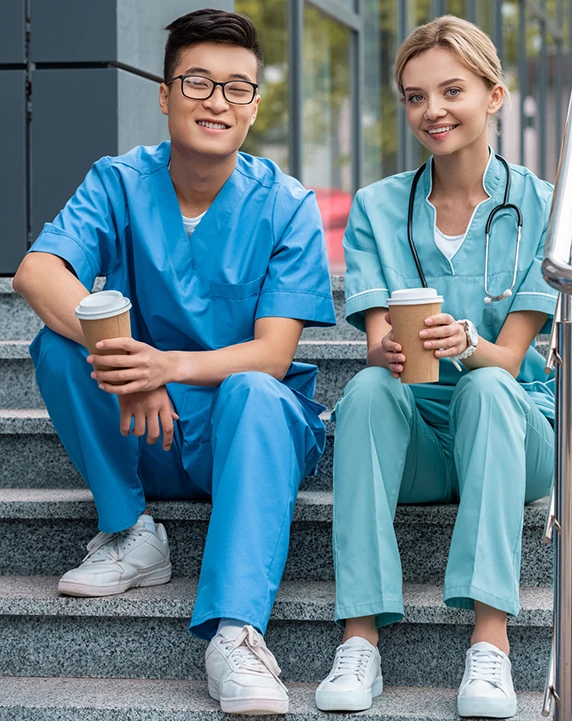 Medical students sitting on stair with coffee