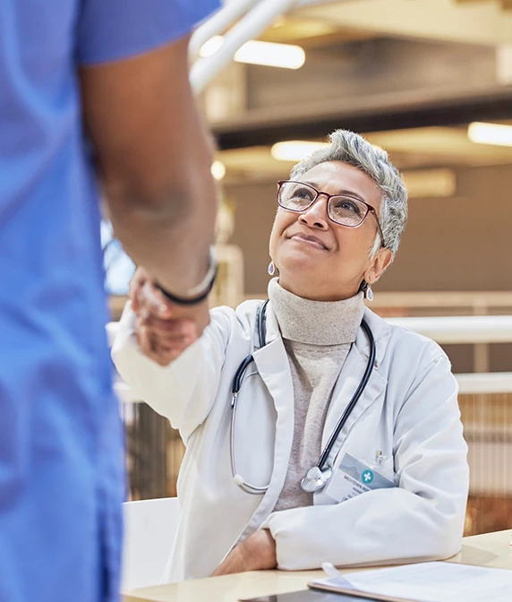 Woman doctor handshake with nurse