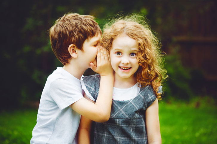 Children sharing a secret