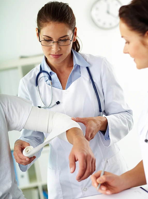 Physicians applying bandages