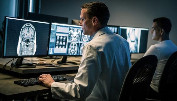 Image of physician at computer reviewing imaging of brain for neurodiagnostics