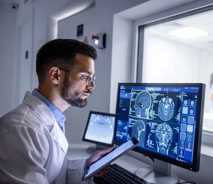 Doctor examining X-ray images in MRI control room