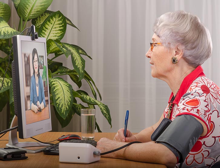Older woman using telehealth services