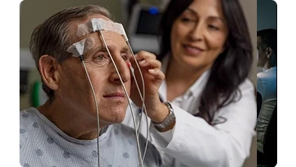 Female Vituity Physician In White Labcoat Adjusting Sensors On Patients Head